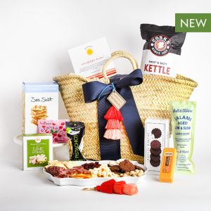 A reusable market basket and a stylish keychain filled with gourmet snacks perfect for move-ins, renewals, or appreciation.