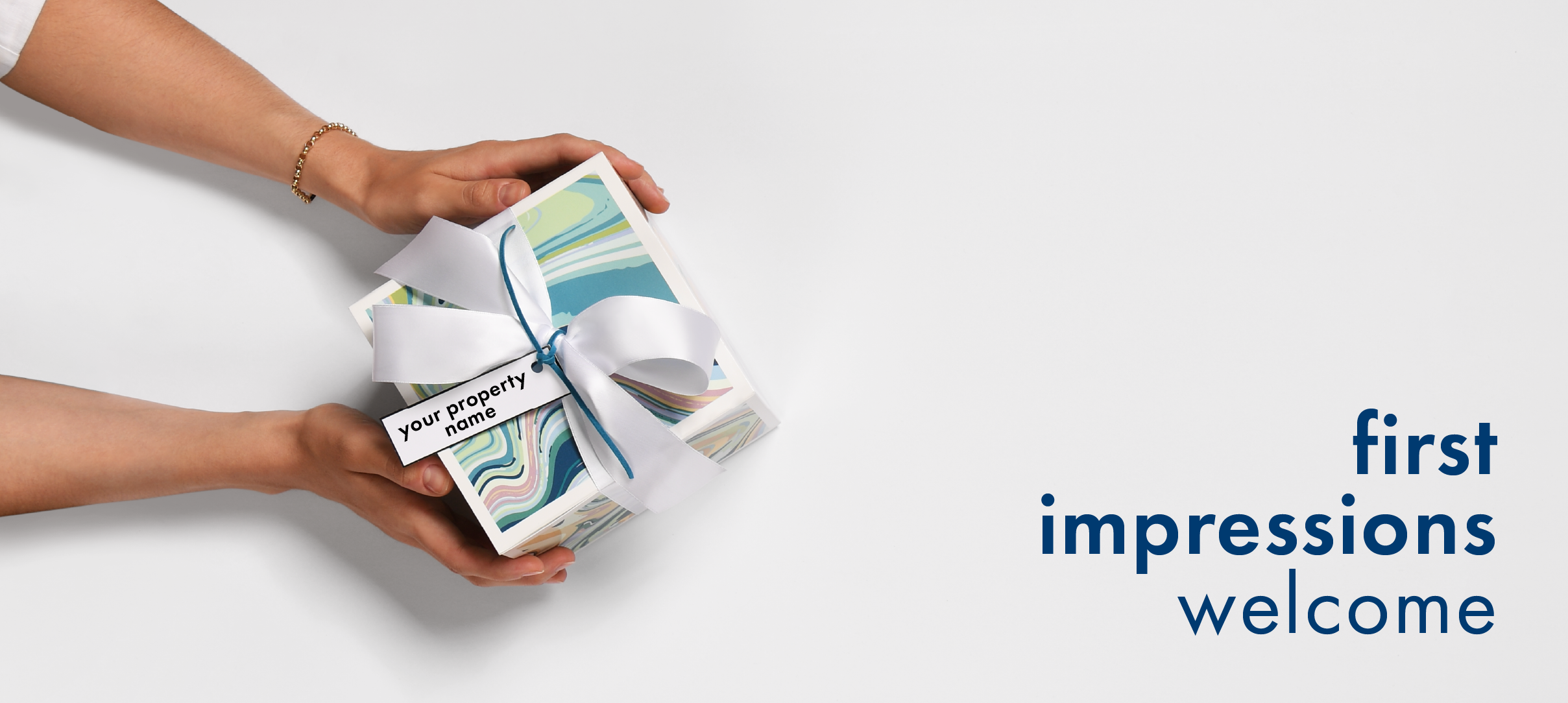 It is an aerial view of a Fresh Paint box on a white background. A woman is holding the box. Blue text reads first impressions welcome.