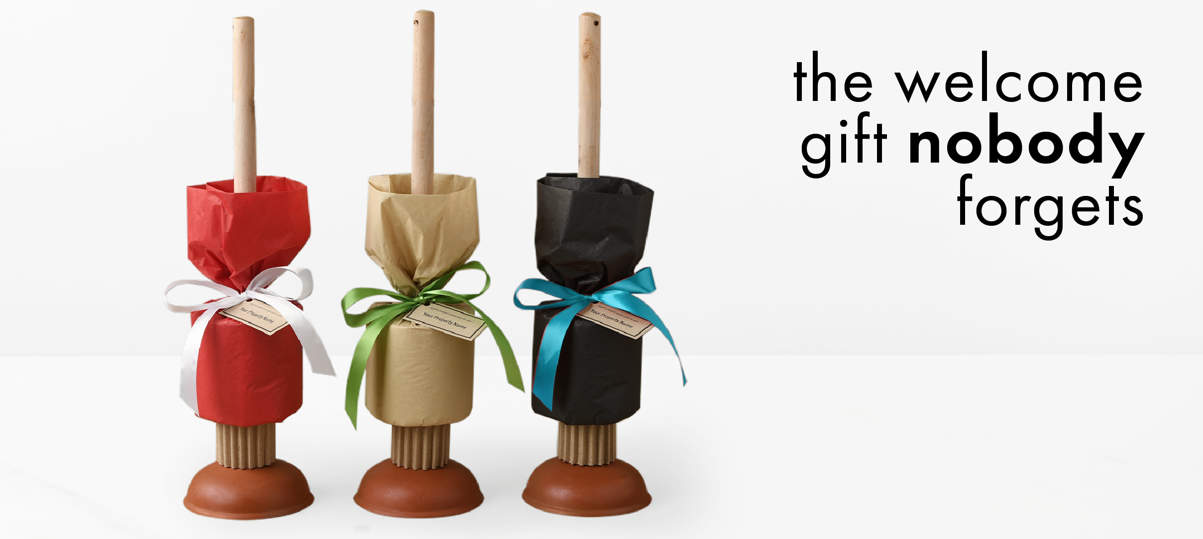 Three plunger gifts with toilet paper wrapped in tissue paper with a ribbon are on the left side. Black text reads "the welcome gift nobody forgets." on the right.
